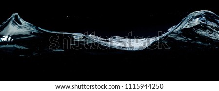 A close-up picture of big water waves isolated on a deep black background