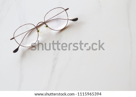Brown glasses on marble working place