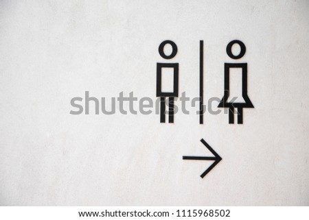 Man and lady toilet sign on white concrete wall background