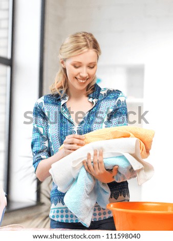 bright picture of lovely housewife with towels.