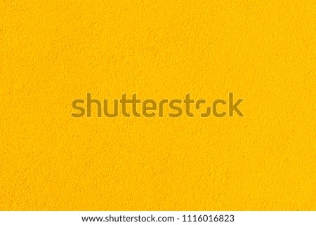 A bright yellow wall. Texture, background concept.