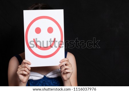 woman holding emoticon smile