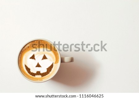 a cup of cappuccino coffee with a picture of a halloween symbol from cinnamon on milk foam Royalty-Free Stock Photo #1116046625