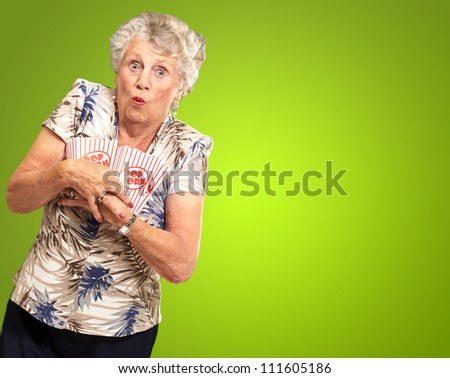 Woman Holding Popcorn Box On Green Background