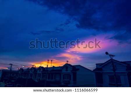 weather vane at sunrise with bright colors in clouds.