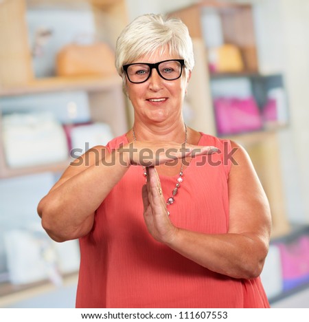 Portrait Of A Senior Woman Showing Time Out Signal, Indoor