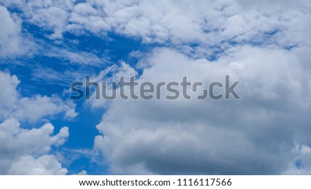 Stock photo of natural cloudscape background. Royalty high-quality free stock image of beautiful bright blue sky with white fluffy clouds on a clear sunny day