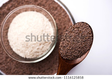 Psyllium husk or isabgol which is fiber derived from the seeds of Plantago ovata, mainly found in India. Served in a bowl over moody background. selective focus
