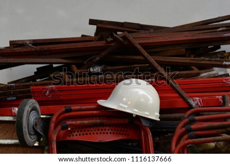 Construction helmet on red steel