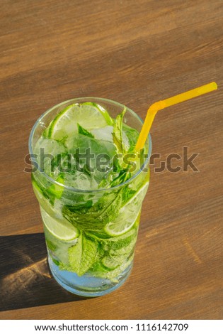 Mojito cocktail with fresh lime, mint and ice