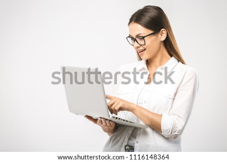 Portrait of happy surprised woman standing with laptop isolated on white background