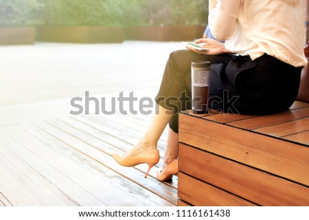 Young attractive woman at the street, browising in internet drinking coffee, Business concept photo