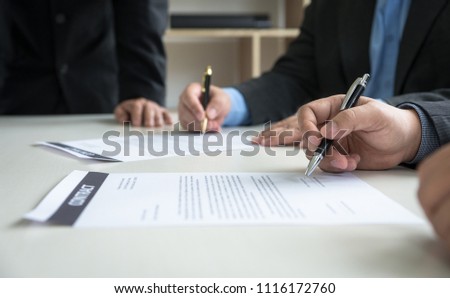 Business Team partners reading a document before signing contract agreement was signed co-investment business.business managers team working with new startup project in office room. Selective focus.