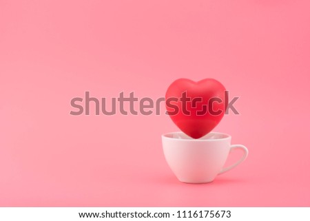 red heart shape in white mug  on pink background.  Valentines Day concept and Health care.
