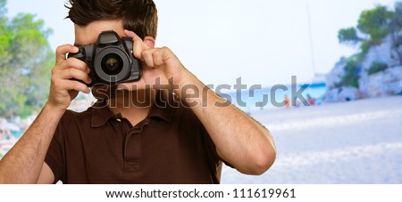 Man Holding Camera, Beach