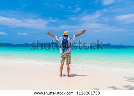 Happy man traveler relaxing on natural sand beach joy fun with clear blue sea water, Outdoor activity tourism Myanmar Thailand, Tourist beautiful destination Asia, Summer holiday vacation travel trip