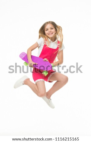 Happy child jump with penny board isolated on white. Little kid smile with skateboard. Fun in motion. Sense of freedom. Childhood development. Carefree skater girl. Active hobby and sport activity.
