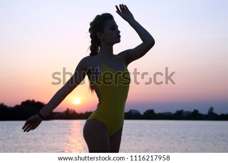 silhouette of athletic girl on the background of sunset

