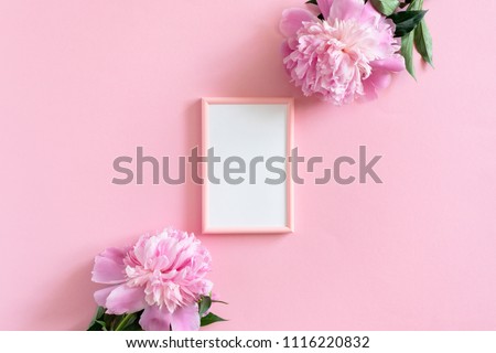 Picture frame mockup and peonies on a pink pastel background