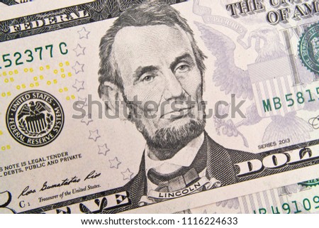 Front of the five dollar bill with a Portrait of President Abraham Lincoln close-up