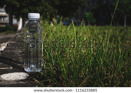 
bottle of water in the grass