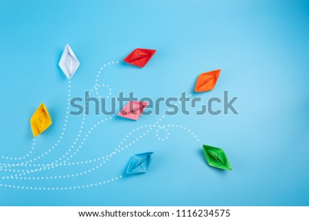 Paper ships on blue background. Business competition, different vision creative and Innovative solution for business concepts.