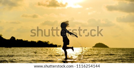 Silhouette of a woman in different pose in the sunset on the sea, Koh Chang island, Thailand