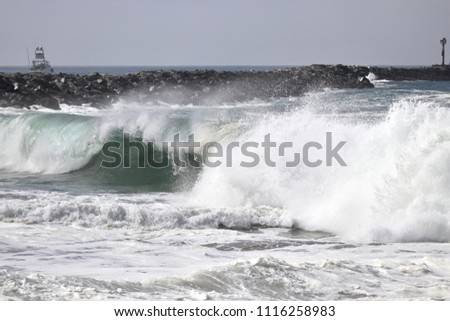 Large powerful waves crash on the shore of The Wedge in Newport Beach California during a south swell 