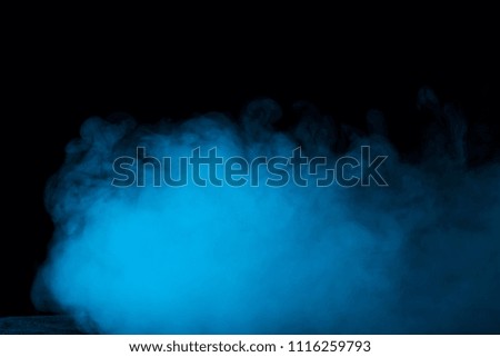 dense and mysterious blue vapor on a dark background an exciting atmosphere