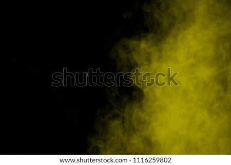 mystical yellow steam on a dark background concept of smoking and addiction