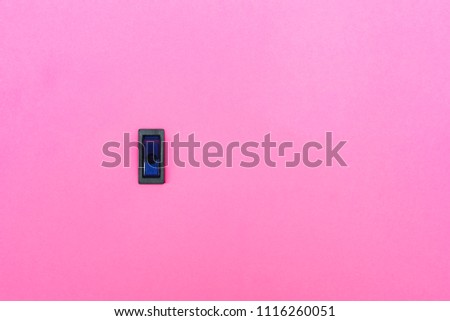 Blue toggle switch on a pink background. Abstract photo with blank empty space for free title