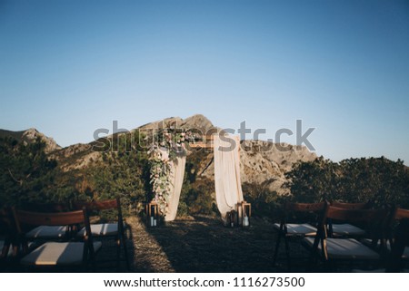 Rustic style wedding arch in sunset light