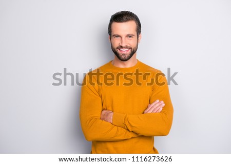 Portrait of attractive self-assured with beaming shiny smile haircut with long furfur wearing casual classic color of mustard sweater macho man standing with folded arms isolated on gray background Royalty-Free Stock Photo #1116273626