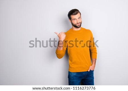 Portrait of cheerful attractive joyful confident guy keeping hand in pocket of jeans hinting pointing on copyspace behind his back isolated on gray background Royalty-Free Stock Photo #1116273776