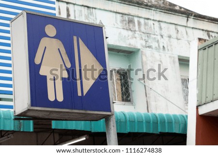 A graphics board with a female figure icon shows the direction of the way to the women's toilets.