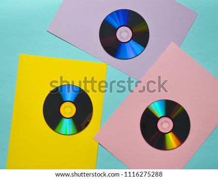 Computer CDs on a colored paper background. Retro Media. Top view
