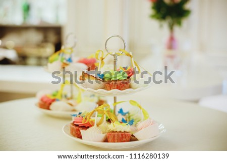 Cupcake stand. Toned image.Candy Bar. Delicious sweet buffet with cupcakes. Sweet holiday buffet. Selective focus.