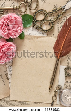 Old letters, antique feather pen, pink rose flowers. Paper background. Vintage flat lay