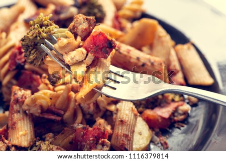 Delicious pasta with vegetables and meat with shallow depth of field, instagram filter.