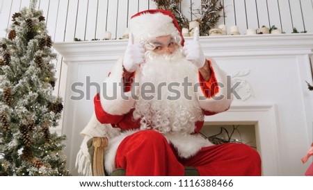 Happy Christmas Santa Claus showing thumbs up