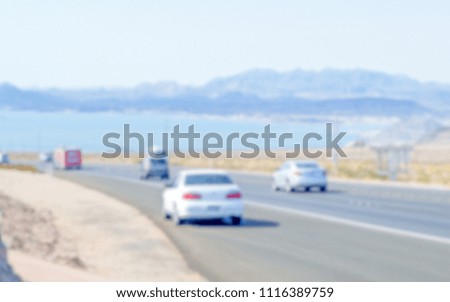 Defocused background of a highway leading to a lake. Intentionally blurred post production for bokeh effect