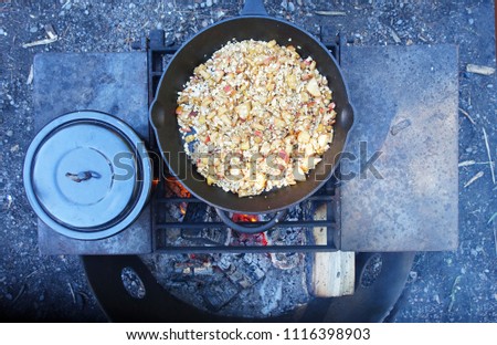 Picture of cooking breakfast (apple crisp),prepared on a wood fire.