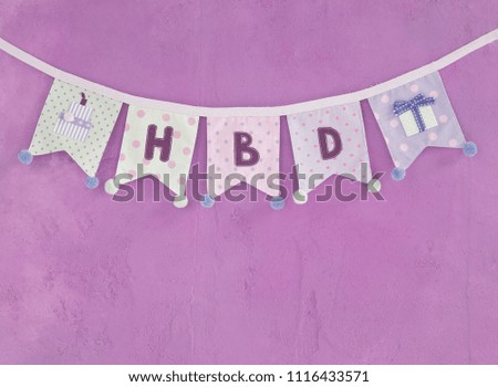 Abstract happy birthday background, design fabric birthday party flag with space on purple concrete background, vintage purple filter tone