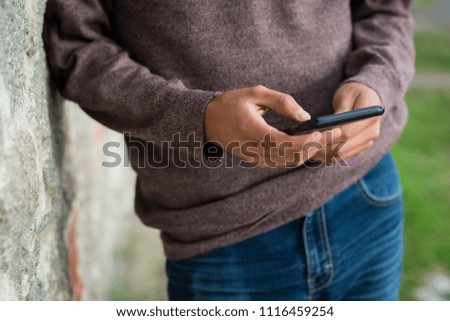 young man texting on cellphone 