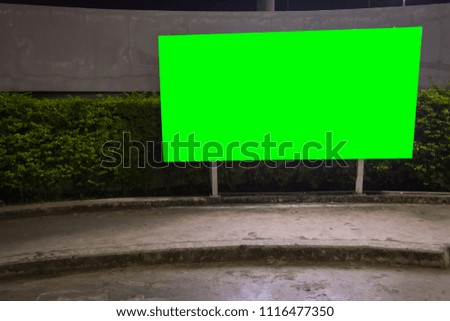 green screen blank billboard ready for new advertisement,lightbox mounted on the wall of store street in a city at night.