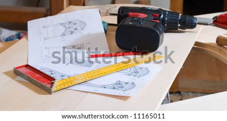 Carpentry's tools on bench with planning of the doors