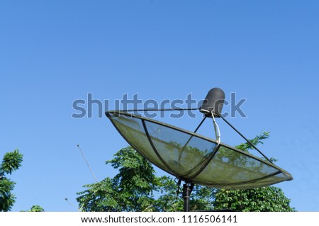 Black satellite dish for telecommunication on  residence roof