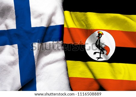 Finland and Uganda flag on cloth texture