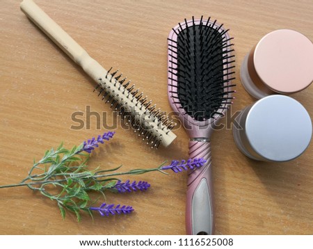 Beautiful composition with cosmetics, flowers and products on brown wooden background, flat lay
