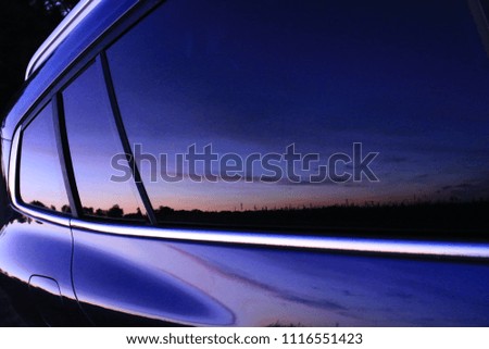 Reflection of the sunset in the car window